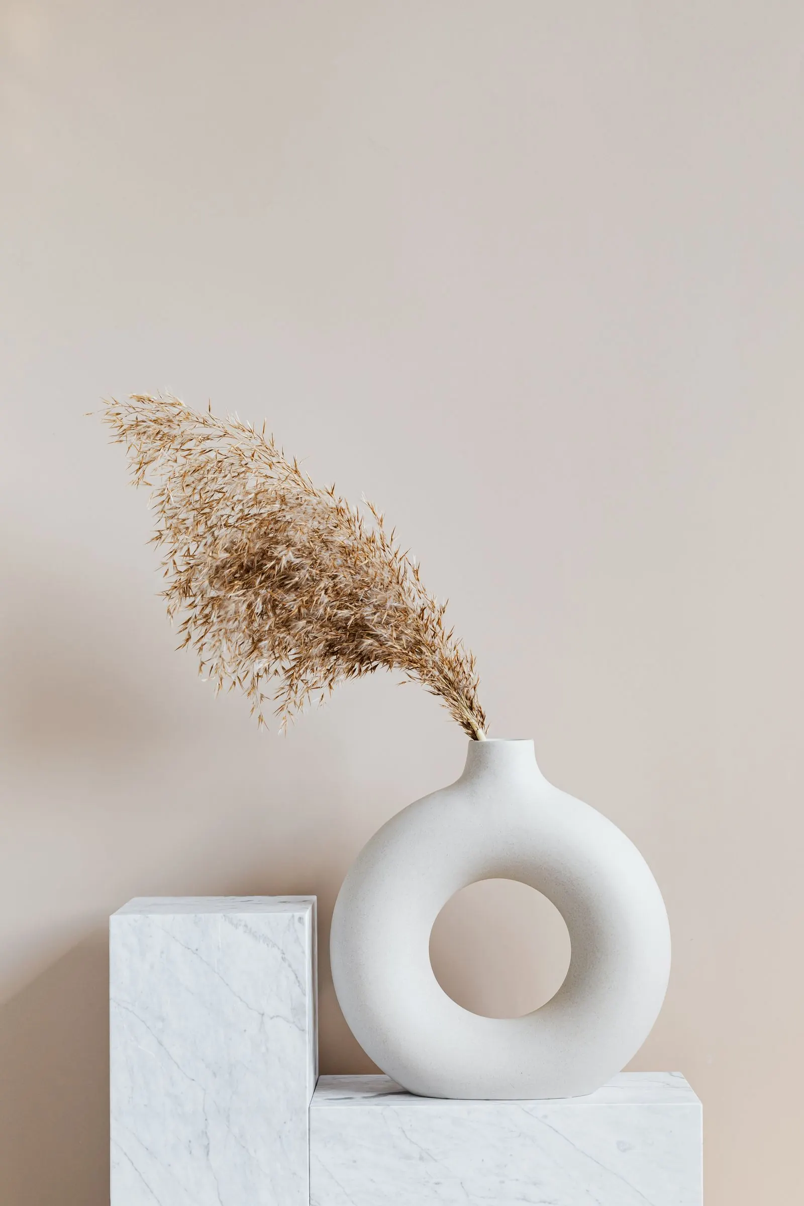 A ceramic vessel with dried grass